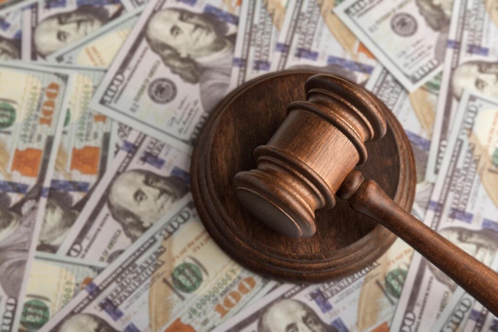 a gavel sitting on top of a pile of cash
